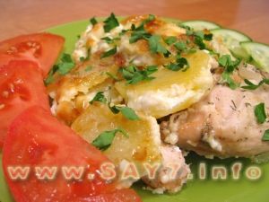 Baked chicken with potatoes under mayonnaise.