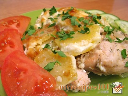 Baked chicken with potatoes under mayonnaise.