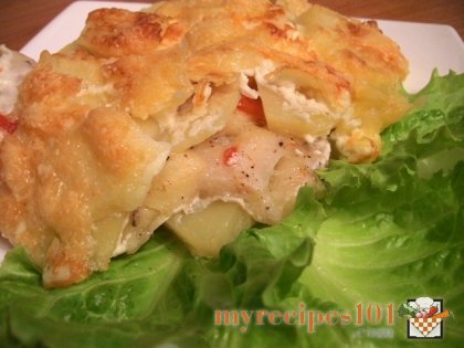 Baked chicken with potatoes under mayonnaise