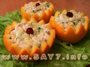 Salad with chicken filet and cucumbers in oranges